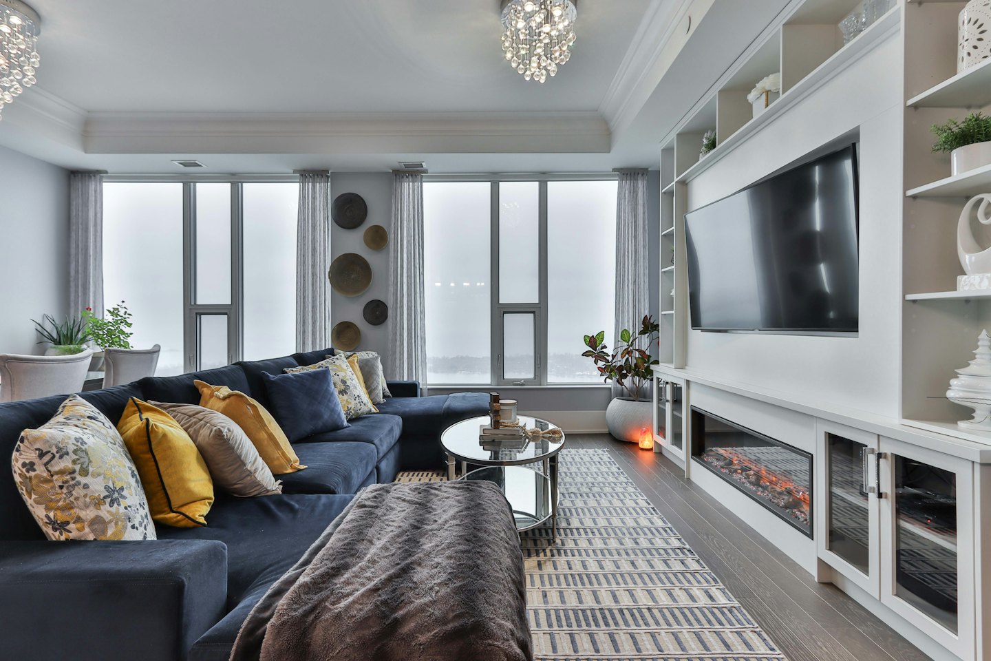 Modern living room with navy sectional and large windows.