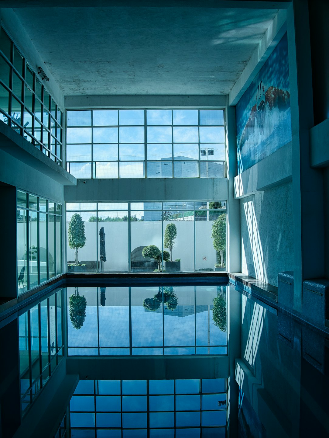 Sunlight reflects on the water of an indoor pool.
